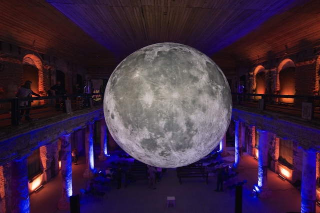 Фестиваль науки Science Fest в Анненкирхе. Макет луны в центре зала. Посетители фестиваля рассматривают макет
