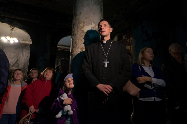 Настоятель Евгений Раскатов и посетители церкви во время освящения креста, перед установкой его на куполе церкви