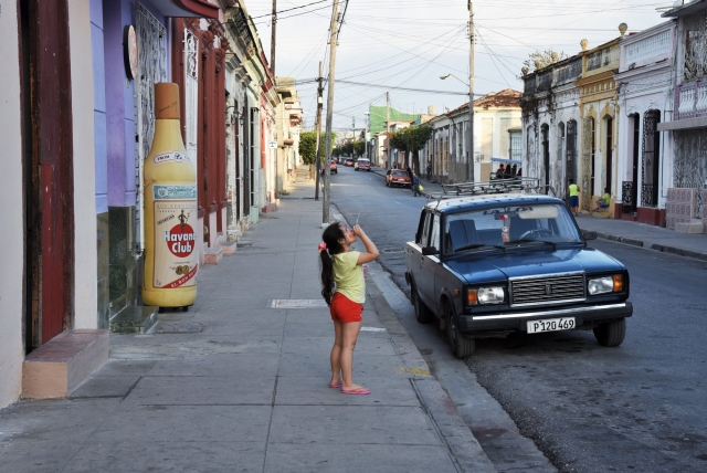 Девочка пускает мыльные пузыри на улице Сьенфуэгоса. Куба