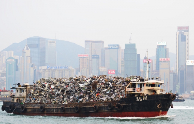 Корабль с мусором в гавани Виктория в Гонконге. Китай 