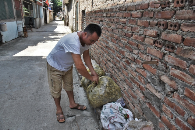 Van Hai собирает змеиную кожу в мешки, которую оптом продаёт в Китай. Винь Сон. Вьетнам